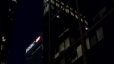 Low-angle-shot-with-slow-motion-travelling-of-the-HSBC-building-and-logo-in-Canary-Wharf,-London