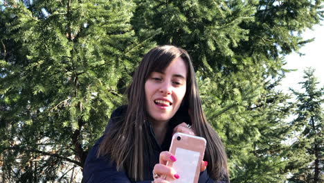 Slowmo-of-young-girl-taking-selfies-with-a-smartphone-using-front-camera-in-a-city-park