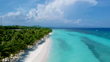 aerial-take-off-along-beautiful-shore-line-of-turquoise-blue-sea-and-palm-trees-on-White-beach,-Panglao-island,-Bohol,-Visayas,-Philippines