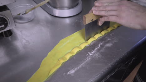 Filled-agnolotti-pasta-being-cut-by-a-chef