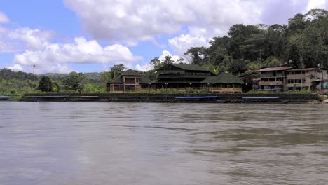 Scenic-Cruise-on-the-Amazon-River-with-view-on-a-small-Village-in-Peru,-South-America