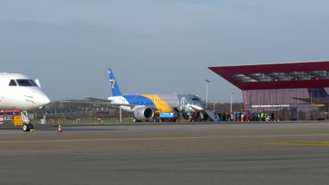 The-new-Embraer-E-190-E2-in-"Shark"-livery-at-the-general-aviation-apron-of-Schiphol-East-in-Amsterdam