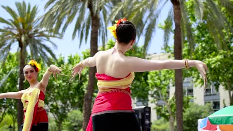 Two-beautiful-thai-girls-dancing-in-a-exhibition-outdoors