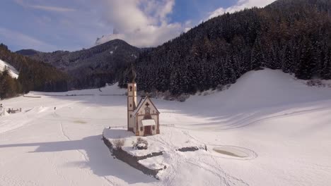 AERIAL:-Church-with-snow-in-Dolomites-in-Italy