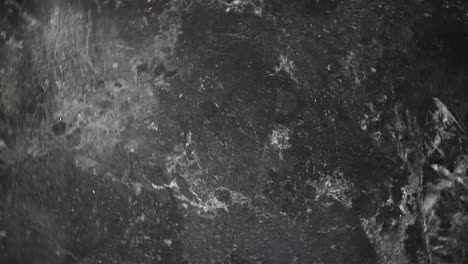 spinning-black-marble-with-gray-veining-background-texture