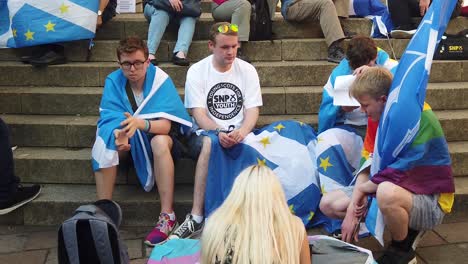 Scottish-Independence-supporters-sitting-on-stone-steps-at-a-rally