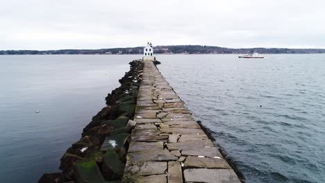 A-boat-cruising-by-the-Rockland-Breakwater-Lighthouse