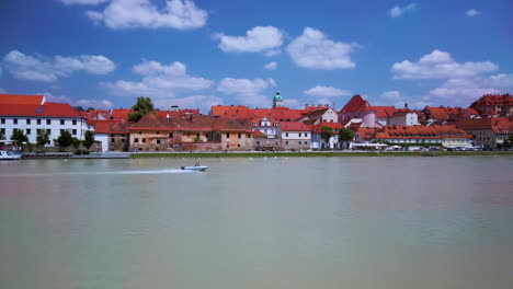 Motorboat-speeding-on-Drava-river,-Lent,-Maribor,-Slovenia