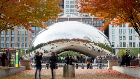 Slow-Shutter-time-lapse-of-people-enjoying-Anish-Kapoor's-Cloud-Gate-in-Chicago's-Millennium-Park-with-all-the-fantastic-Fall-colors-in-the-trees-and-on-the-ground-in-November
