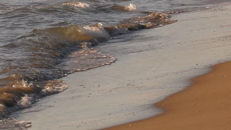 Ocean-waves-on-sandy-beach,-close-up-sea-shore-slow-motion