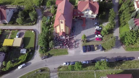 Aerial-shot-of-a-wedding-ceremony-in-a-small-church-on-a-coutryside