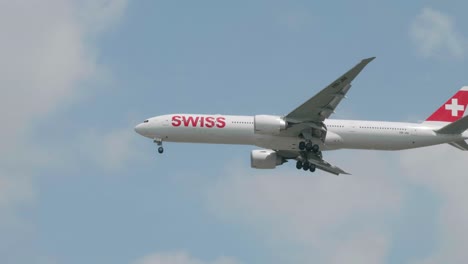Swiss-Boeing-777-3DE-HB-JNI-approaching-before-landing-to-Suvarnabhumi-airport-in-Bangkok-at-Thailand
