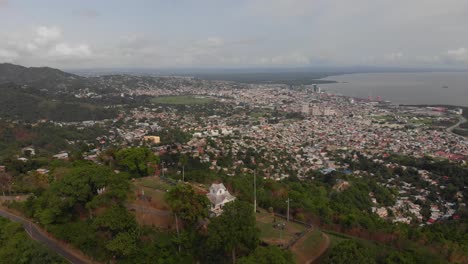 Epic-aerial-footage-of-a-fort-overlooking-the-Caribean-port-city-of-Port-of-Spain,-Trinidad