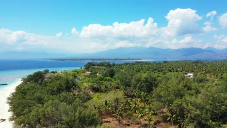 tropical-Gili-Island-in-Lombok,-aerial-panorama,-sky-and-mountains-in-the-background