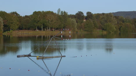 Pan-right-view-of-lake-with-basketball-hoop-in-water-for-water-sports