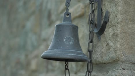 An-ancient-bell-next-to-a-castle-in-slow-motion