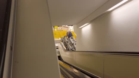 View-of-a-man-working-on-an-escalator-in-a-mall