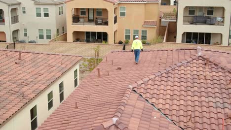 Male-installer-surveying-roof-of-house-before-solar-panel-installation