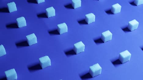 Trucking-4K-view-of-a-unique-cubic-background-with-white-sugar-cubes-arranged-in-rows-on-a-dark-blue-background,-3D-effect