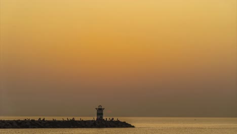Sunset-on-the-lighthouse-of-Scheveningen-harbor-at-the-summer-hottest-day-ever