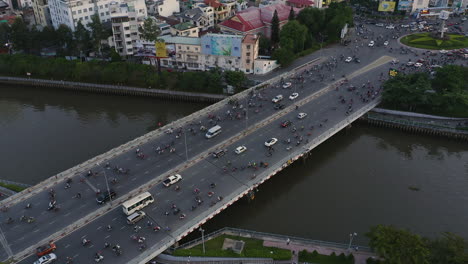 Evening-tracking-aerial-view-of-Dien-Bien-Phu-Bridge,-Binh-Thanh-district,-Ho-Chi-Minh-City,-which-crosses-the-Hoang-Sa-canal