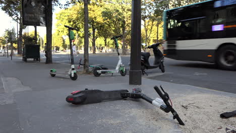 Electric-scooters-lying-on-the-sidewalk-and-misplaced-in-the-streets-of-Paris-near-the-Champs-ElysÃ©es