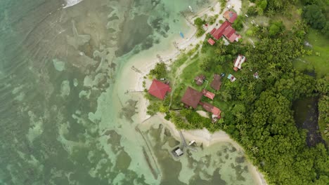 Aerial-shot-of-some-beach-houses-on-beautiful-beach,-Bocas-del-Toro,-Panama