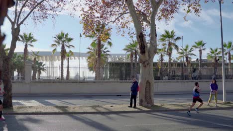 Athletes-Running-On-The-Street-In-Malaga,-Spain-During-The-Zurich-Marathon-2019-Event---wide-slowmo-shot