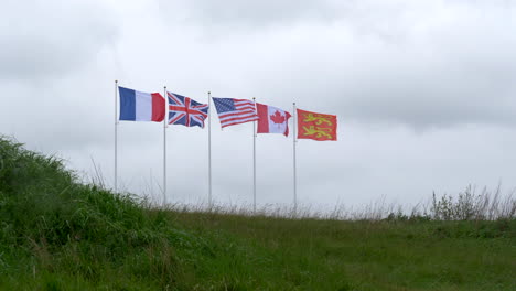 Flag-of-France-next-to-its-western-allied-countries-United-Kingdom,-United-States-of-America,-Canada-waving-beside-Normandy-flag,-all-involved-in-Operation-overlord,-D-day