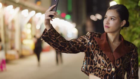 Sunningly-seductive-Asian-girl-wearing-leopard-print-takes-a-selfie-with-her-smartphone-then-posts-it-on-social-media