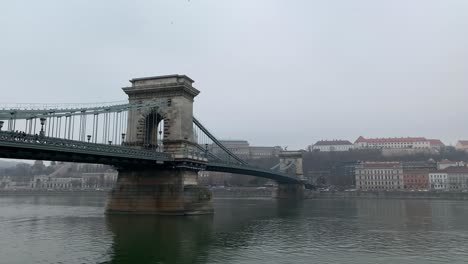 Panning-on-closeup-chain-bridge-on-rainy-day-in-Budapest
