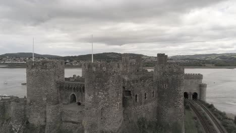 Medieval-landmark-historic-Conwy-castle-aerial-view-above-Welsh-seaside-town-landscape