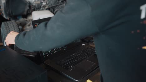 Man-Preparing-a-Laptop-to-3D-Scan-a-Mazda-RX7