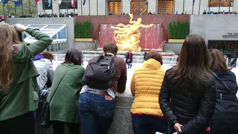 POV-tourist-walking-down-the-stairs-to-side-of-rink-in-Rockefeller-Center