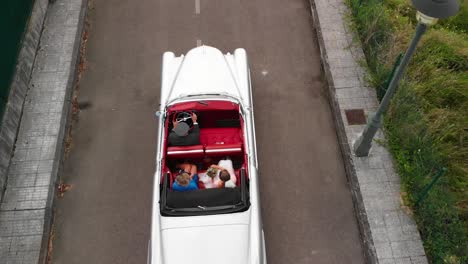 Aerial-shot-of-a-bride-and-her-mother-in-a-vintage-luxury-car