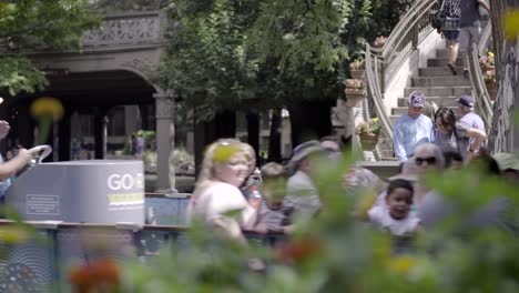 A-rack-focus-shot-reveals-tourists-riding-in-boat-tour-of-the-famous-San-Antonio-Riverwalk-in-Texas