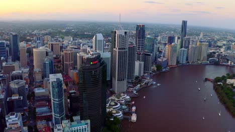 Modern-High-Rise-Buildings-At-Brisbane-Central-Business-District-In-Front-Of-Brisbane-River-In-Queensland,-Australia-At-Sunset