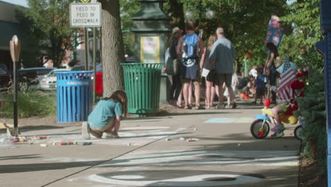 Sister-and-Brother-Drawing-on-Sidewalk-with-Chalk-During-Community-Event