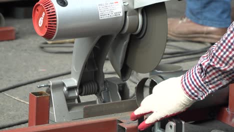 Cutting-A-Metal-Pipe-tube-With-Cut-off-Machine---close-up-no-hands