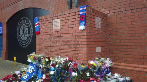 A-wide-shot-of-flowers-resting-at-the-statue-of-John-Greig