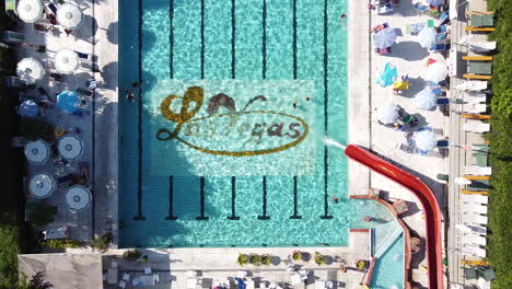 Aerial-shot-over-Las-Vegas-swimming-pool-with-few-people-due-to-the-Coronavirus-pandemic