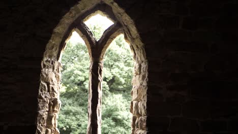 Ornate-arch-window-frame-on-Georgian-building-in-England-medium-tilting-shot