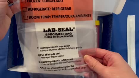 Hand-holding-a-LAB-SEAL-Specimen-Bag-for-COVID19-IN-HOME-TESTING