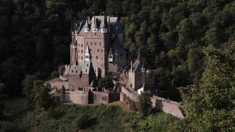 Romantic-Burg-Eltz-Castle-nestled-in-forrested-valley-lit-up-by-morning-sun