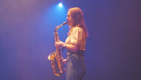 Woman-Playing-Saxophone-in-Haze-Under-Stage-Lights