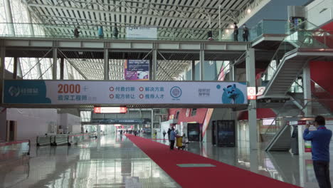 Walking-inside-almost-empty-hall-of-Canton-Fair-exhibition-complex-with-a-few-visitors-during-COVID-19-pandemic