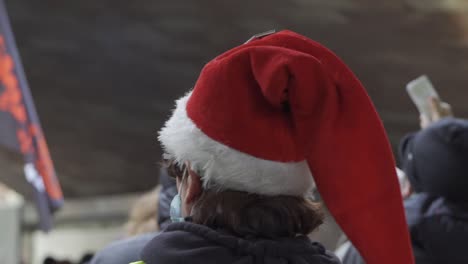 Women-with-Christmas-hat-participate-in-demonstration-against-proposed-new-security-law-in-France,-article-24
