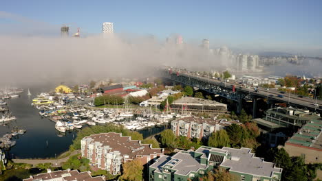 Aerial-rise-over-Granville-Island,-Vancouver-on-a-foggy-morning
