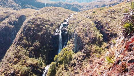 4k-daytime-video-with-a-high-waterfall-stream-being-revealed-in-the-Peruvian-Andes---5-Lakes-of-Pichgacocha,-Ambo,-Huanuco