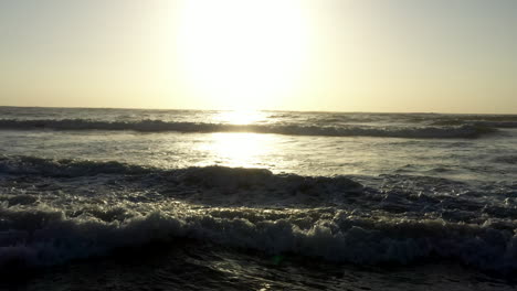 AERIAL-Golden-Sunrise-Low-Over-Crashing-Ocean-Waves